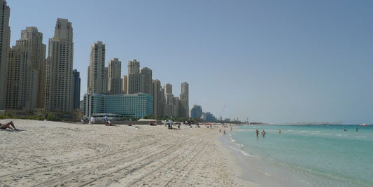 family enjoying beach in Dubai skyline